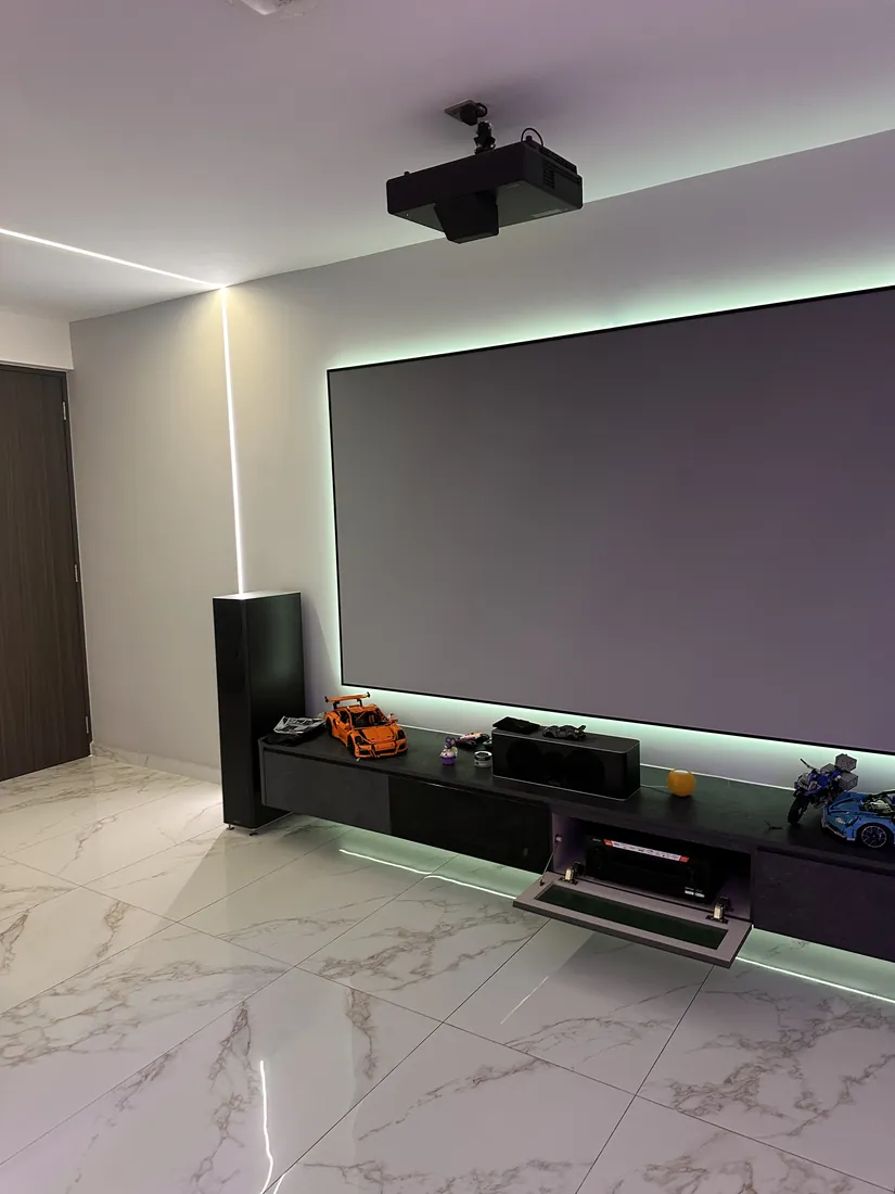 Home theatre at Cedar Avenue with a projector screen, mint bias lighting behind it and an underlit floating console