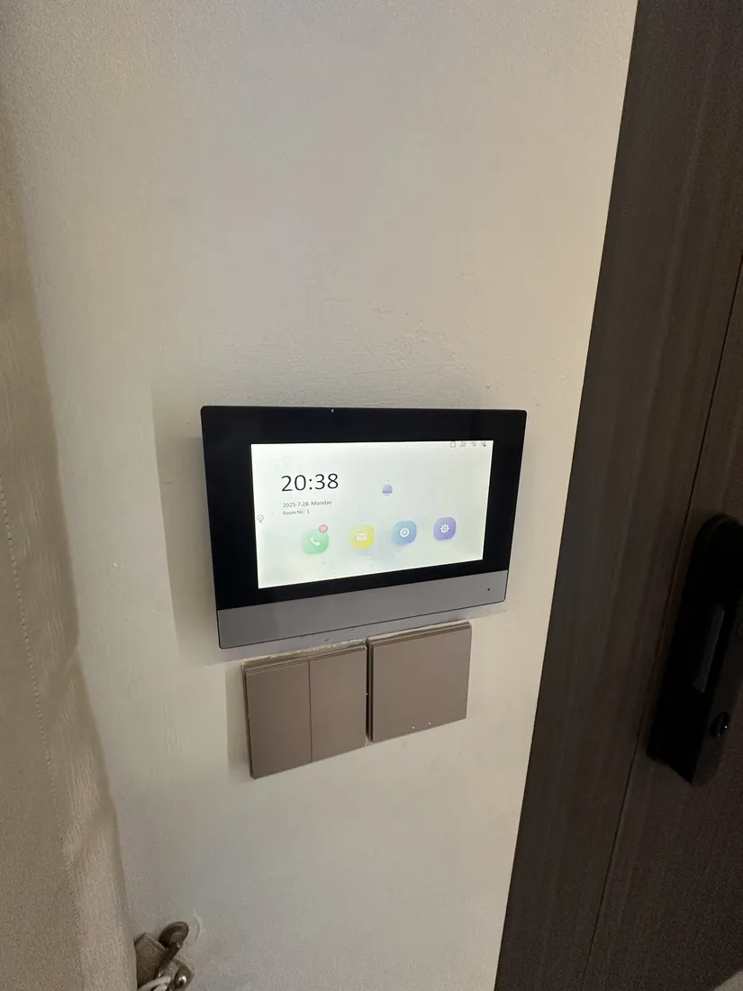 Wall-mounted control panel at Cedar Avenue beside two smart switch plates