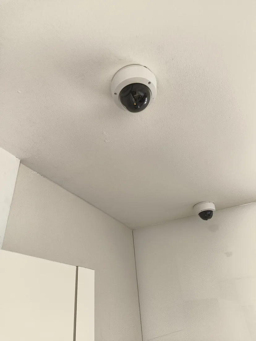 A ceiling-mounted dome camera covering a corridor.