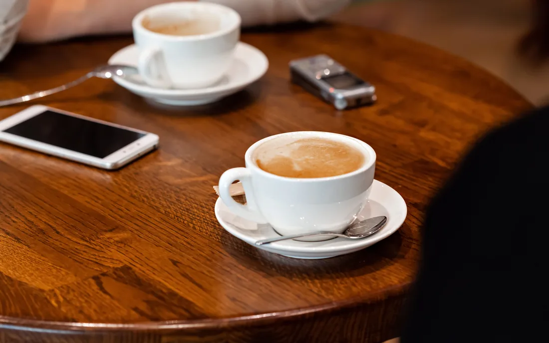 A design session over coffee, with notes and a phone on the table