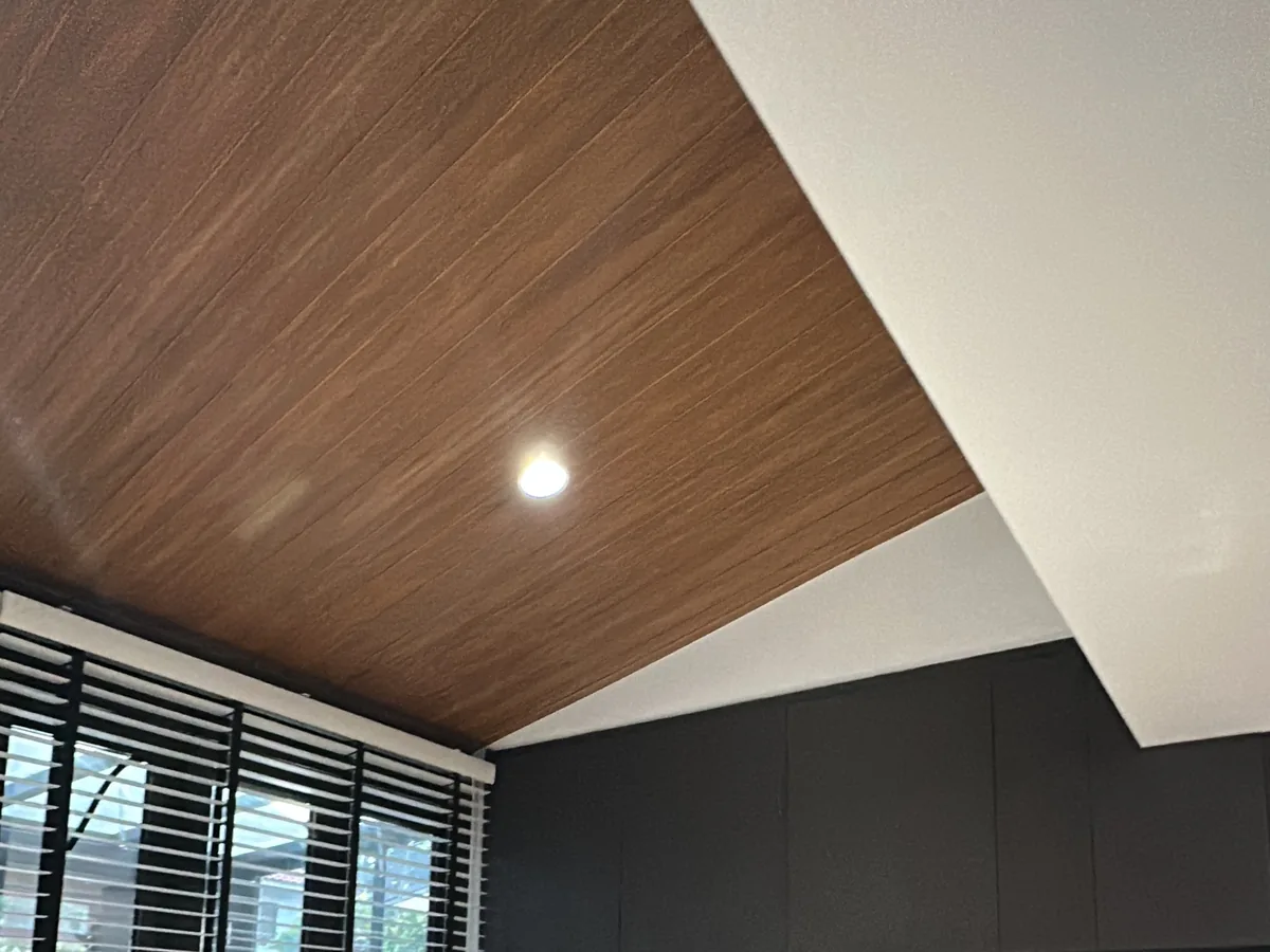 Recessed downlight in the timber-clad balcony ceiling, controlled without a wall switch