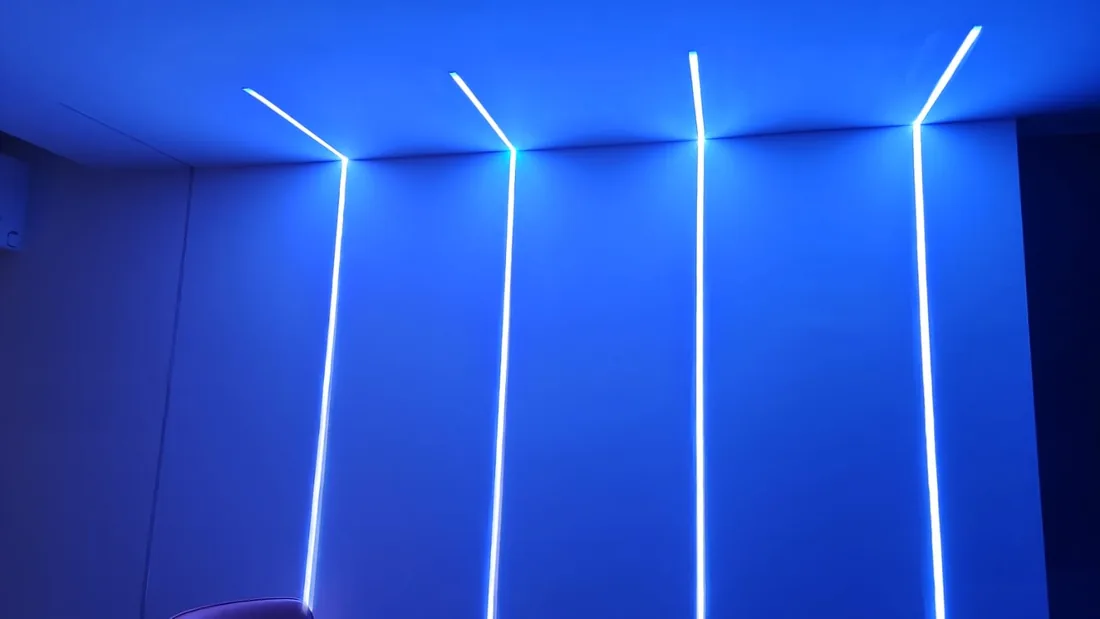 Vertical WLED strips washing a wall and ceiling in blue